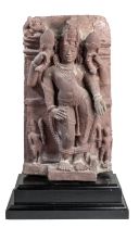 A PINK SANDSTONE RELIEF PANEL DEPICTING SURYA, CENTRAL INDIA, 11TH/12TH CENTURY