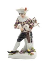 A MEISSEN FIGURE OF HARLEQUIN PLAYING A PUG, 20TH CENTURY