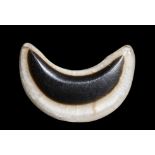 A SEMITIC AGATE NECKLACE ELEMENT IN THE SHAPE OF A CRESCENT MOON.