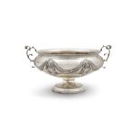 A SILVER CIRCULAR TWO HANDLED BOWL ON STAND London, c.1898, with repousse drapery swags,