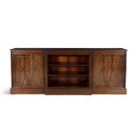 A 19TH CENTURY FLAME MAHOGANY BREAKFRONT BOOKCASE the moulded top above central open shelved