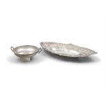 A STERLING SILVER NAVETTE SHAPED DISH the rim embossed and chased with scrollwork design;
