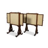 A PAIR OF IRISH MAHOGANY FIRE SCREENS, C.1820 with pull-out panels to either side,