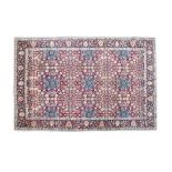 A SEMI-ANTIQUE TURKISH RUG the central reserve filled with large and small flower heads in blue,