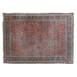 A KASHAN WOOL RUG, CENTRAL PERSIA, C.1920 the red ground with an all over directional grid of