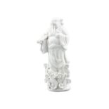 A CHINESE BLANC DE CHINE FIGURE OF A BUDDHIST DEITY STANDING IN CLOUDS, Dehua, 19th Century,
