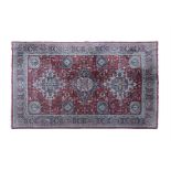 A LARGE TURKISH WOOL CARPET the red ground with three central medallions and eight outer ones,