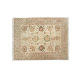 ***WITHDRAWN*** A CREAM GROUND RUG, with trailing vines, the central reserve woven with flower