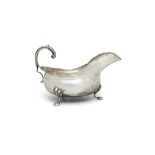 AN EDWARDIAN SILVER OVAL SAUCEBOAT Chester 1908, raised on shell and paw feet and with 's'