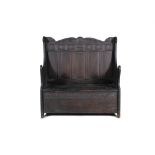 A JACOBEAN STAINED OAK SETTEE, of rectangular form, the crest rail carved with scroll work,