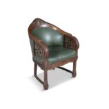 AN OAK, ELMWOOD AND LEATHER UPHOLSTERED LIBRARY CHAIR, 19TH CENTURY the arched tub back crested