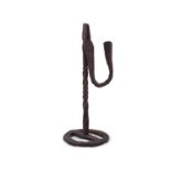 A FORGED IRON RUSH LIGHT, the turned centre pillar on circular base with turned and curved handle.