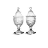 A PAIR OF FLAT-CUT URNS AND COVERS c.1790, probably Irish, the domed covers with knobbed finials,