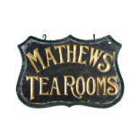 A 19TH CENTURY FORGED IRON-FRAMED, SHIELD-SHAPED, DOUBLESIDED SIGN for Matthew's tea rooms,