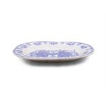 A BLUE AND CREAM SPONGEWARE DISH, the central reserve decorated with flowers and birds. 41cm wide