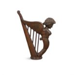 A 19TH CENTURY STAINED CARVED WOODEN MODEL OF HIBERNIA HARP, and raised on a circular base.