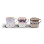 THREE SPONGEWARE MUGS, decorated with flowers in blue, brown and red. Each 10 (h) x 10 (d)cm (3)