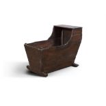 A 19TH CENTURY STAINED WOOD CRADLE, of rectangular tapering form, on a rocking base.