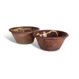 A PAIR OF TERRACOTTA MILK CROCKS, the interior decorated with poured yellow and brown glaze,