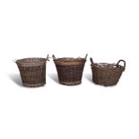 A COLLECTION OF THREE LARGE WOVEN BASKETES, each of tapering form with plain turned twisted handles.