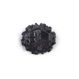 AN IRISH BOG OAK CARVED BROOCH OF BLARNEY CASTLE, the central reserve surrounded by carved