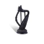 A 19TH CENTURY IRISH CARVED BOG OAK MODEL OF A HARP, with fluting and diamond cuts,