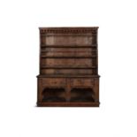 A 19TH CENTURY STAINED PINE DRESSER, the moulded cornice above four open shelves, with guard rails,