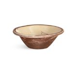 A TERRACOTTA MILK CROCK, the cream interior, decorated with brown banding on the moulded rim,