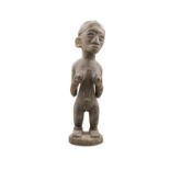 AN AFRICAN FANG FERTILITY FIGURE, modelled as a standing girl, on circular base. 61cm high