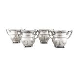 A FINE SET OF FOUR GEORGE IV SILVER PLATED WINE COOLERS IN NEO-GRECIAN STYLE of baluster form,