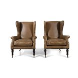 A PAIR OF REGENCY CLOSE NAIL WINGBACK ARMCHAIRS, each upholstered in light brown/beige leather,