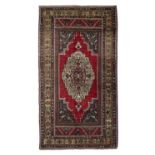AN OLD TAŞPINAR WOOL RUG, CENTRAL TURKEY, C.1970, 270 x 147cm the central reserve woven with a