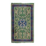 A DONEGAL WOOL RUG the rectangular centre field woven with oval blue medallion and outer borders,