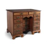 A GEORGE III PALE MAHOGANY KNEE-HOLE DESK, C.1760 with moulded rim above two frieze drawers and