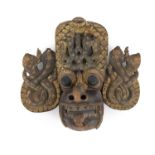 AN OCEANIC POLYCRHOME WALL MASK OF A MYTHICAL BEAST HEAD, PROBABLY BALINESE applied to each