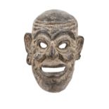A PACIFIC ISLANDS PIGMENTED CEREMONIAL MASK mounted on display stand. The mask 28cm long