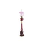 A VICTORIAN RUBY GLASS AND BRASS MOUNTED TALL MALLET SHAPED OIL LAMP with glass reservoir,