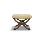 AN OAK FRAMED STOOL, 19TH CENTURY the cross-over frame supporting an upholstered dished with paw