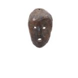 A PACIFIC ISLANDS ROOTWOOD MASK with pierced eyes and mouth on perspex display stand.