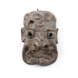 A PACIFIC ISLANDS CARVED WOOD MASK, 19TH CENTURY with pierced eyes applied with goat skin