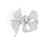 A DIAMOND BOW BROOCH, CIRCA 1935 The elegant stylised ribbon bow highlighted with a series of