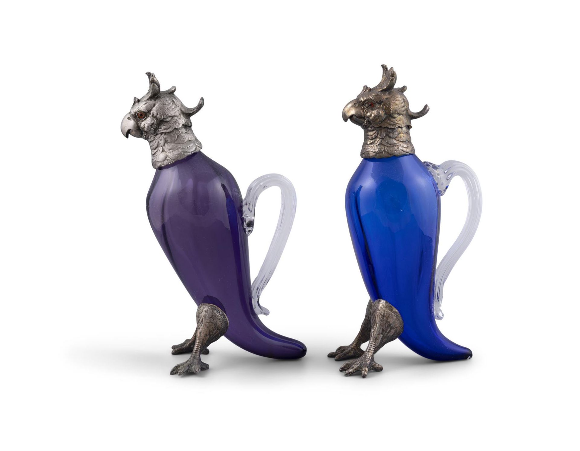 A PAIR OF CONTINENTAL PURLE AND BLUE GLASS DECANTERS IN THE FORM OF PARROTS, with silver
