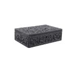 A BOG OAK CARVED BOX, of rectangular shape, with carved foliage in relief, the hinged lid opens