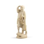 *A JAPANESE IVORY CARVING OF STANDING FISHERMAN Meiji - Taisho period, late 19th/early 20th