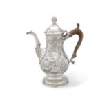 AN IRISH 18TH CENTURY SILVER COFFEE POT Dublin 1772, of circular baluster form with repousse,