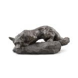 AN EARLY 20TH CENTURY BRONZED MODEL OF A CROUCHING FOX signed Bartelier, on a rocky base. 41.