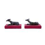 A PAIR OF BRONZE MODELS OF RECUMBENT GREYHOUNDS, FRENCH 19TH CENTURY with ormolu gilt collars,