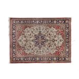 A PERSIAN SILK RUG, SEMI-ANTIQUE WITH CENTRAL FOLIATE MEDALLION on an orange and cream ground