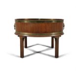 A 19TH CENTURY MAHOGANY BRASS BOUND OVAL WINE COOLER fitted with detachable liner and applied