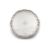 A GEORGE V SILVER SALVER Sheffield 1934 of shaped circular form with pie crest rim,
